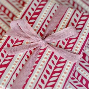 A parcel wrapped with Magnolia ribbon and Charleston Border paper by Cambridge Imprint