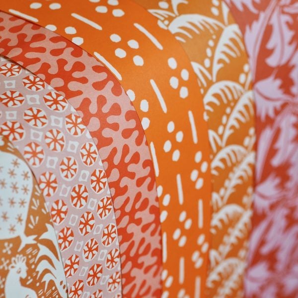 A selection of orange patterned papers by Cambridge Imprint