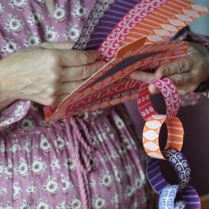Making patterned paper chain in pinks, oranges and blues